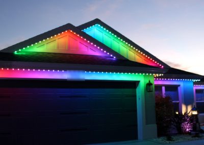 Trimlight 3L permanent roofline lighting showing a full colour gradient on a home in The Villages, Florida
